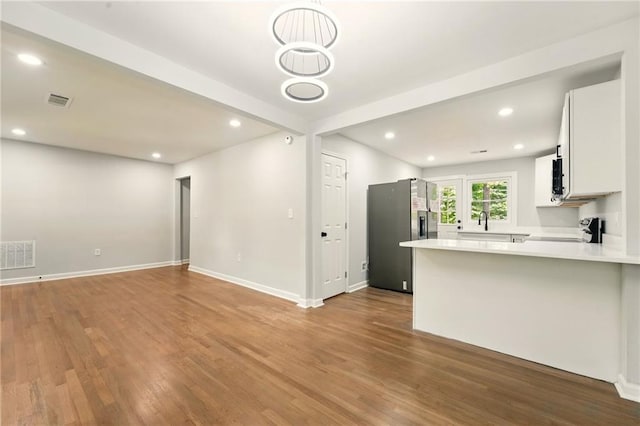163 Oakcliff Ct, South Fulton, GA 30331 - kitchen featuring range, stainless steel fridge, wood finished floors, and recessed lighting