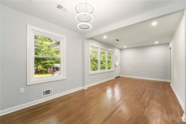 163 Oakcliff Ct, South Fulton, GA 30331 - empty room with healthy amount of natural light, wood finished floors, baseboards, and recessed lighting