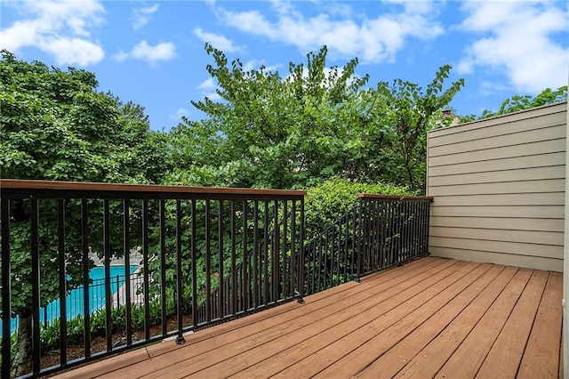 wooden terrace with an outdoor pool