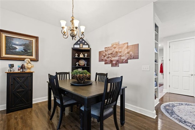 dining room with baseboards, an inviting chandelier, and wood finished floors