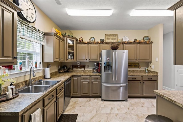 kitchen featuring dishwashing machine, stainless steel fridge, a sink, and glass insert cabinets