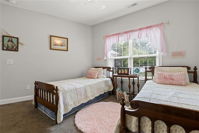 bedroom with carpet flooring, visible vents, baseboards, and ceiling fan