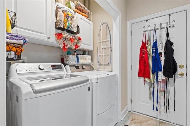 laundry room with baseboards, marble finish floor, washing machine and dryer, and cabinet space