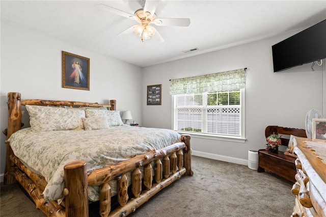 carpeted bedroom featuring visible vents, baseboards, and a ceiling fan