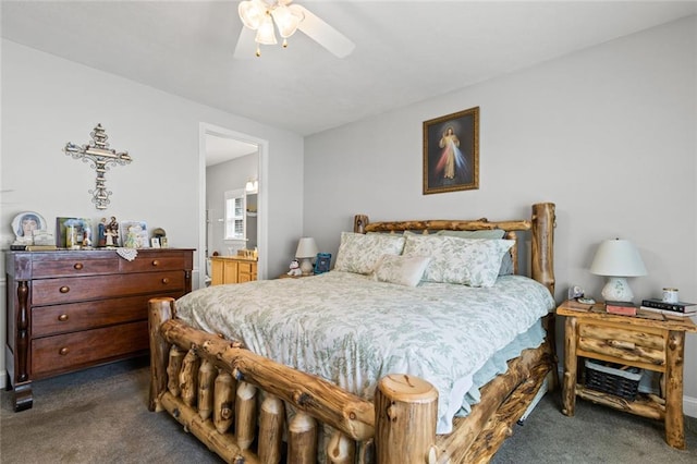 carpeted bedroom with ensuite bathroom and ceiling fan