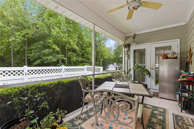 sunroom / solarium with outdoor dining space, french doors, and ceiling fan