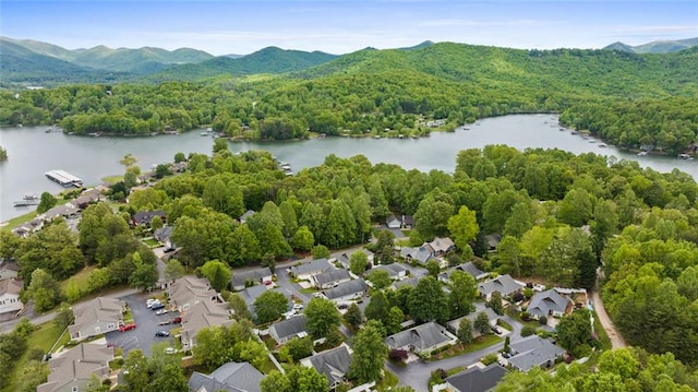 bird's eye view with a water and mountain view, a residential view, and a view of trees