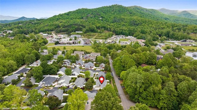 bird's eye view featuring a forest view and a mountain view