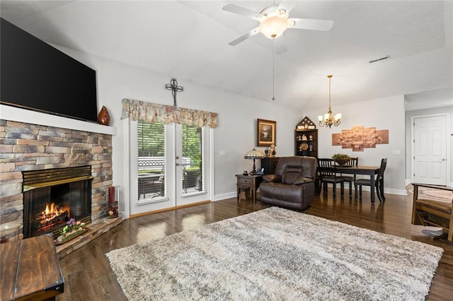 living room featuring visible vents, wood finished floors, lofted ceiling, and ceiling fan with notable chandelier