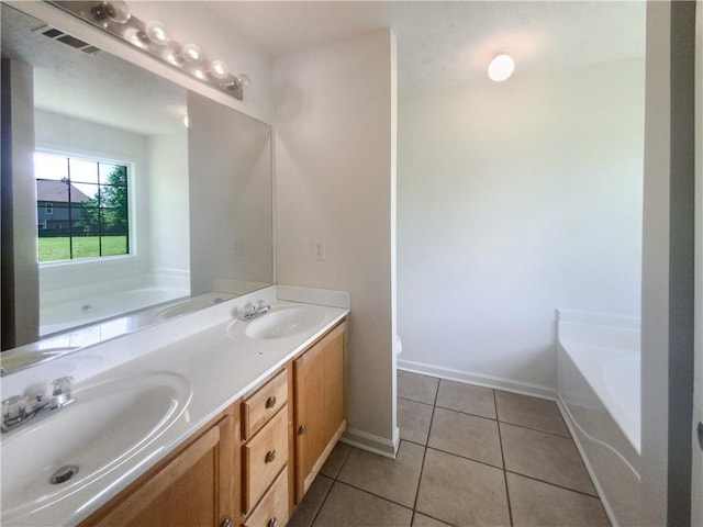 bathroom featuring double vanity, tile patterned flooring, and a tub to relax in