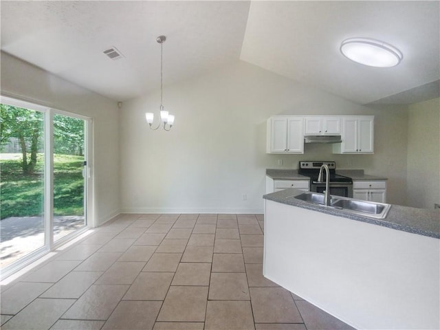 kitchen featuring vaulted ceiling, a wealth of natural light, light tile patterned floors, and stainless steel range with electric stovetop