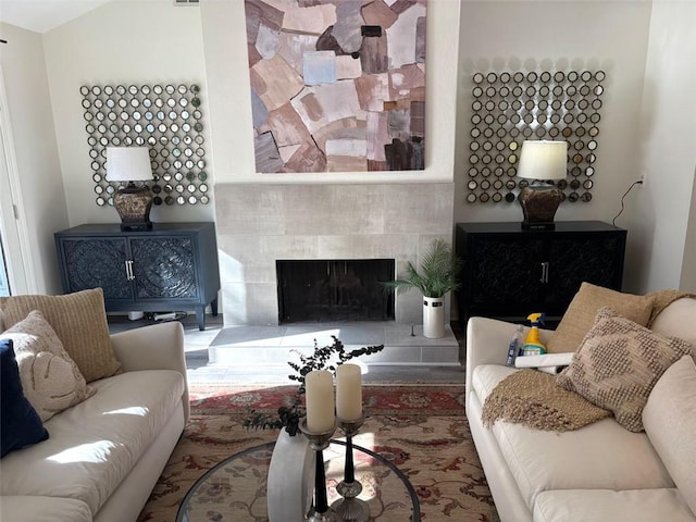 living area featuring a tile fireplace
