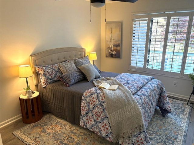 bedroom with baseboards and wood finished floors
