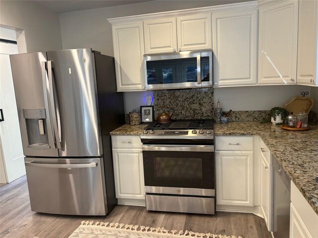 kitchen with appliances with stainless steel finishes and white cabinets