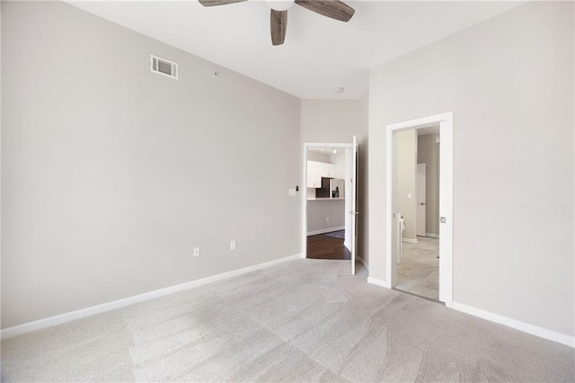 5300 Peachtree Rd Unit 3207, Chamblee, GA 30341 - unfurnished bedroom with light colored carpet, stainless steel refrigerator with ice dispenser, and a ceiling fan