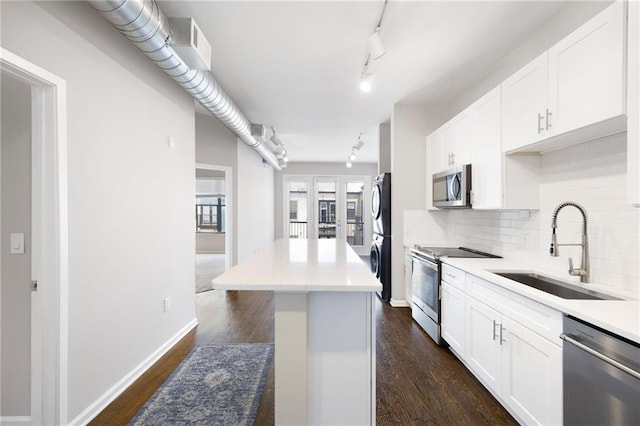 5300 Peachtree Rd Unit 3207, Chamblee, GA 30341 - kitchen with stainless steel appliances, tasteful backsplash, track lighting, and white cabinetry
