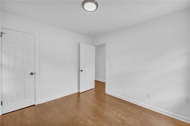 empty room with hardwood / wood-style floors