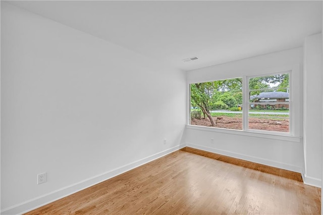 spare room with hardwood / wood-style floors