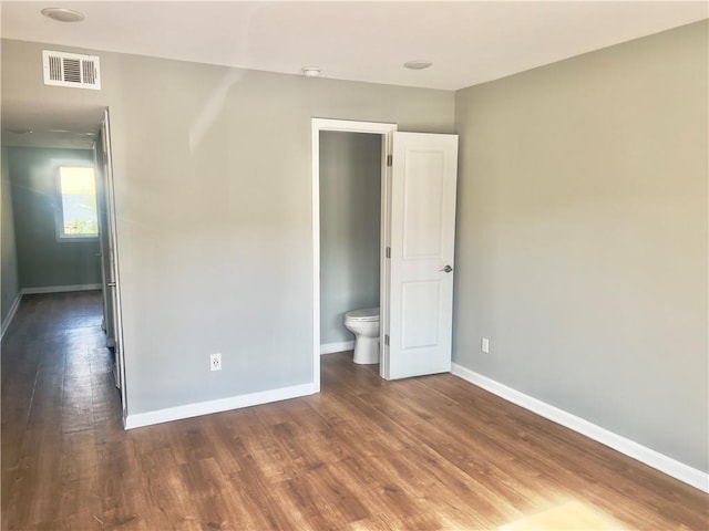 unfurnished bedroom featuring dark hardwood / wood-style floors