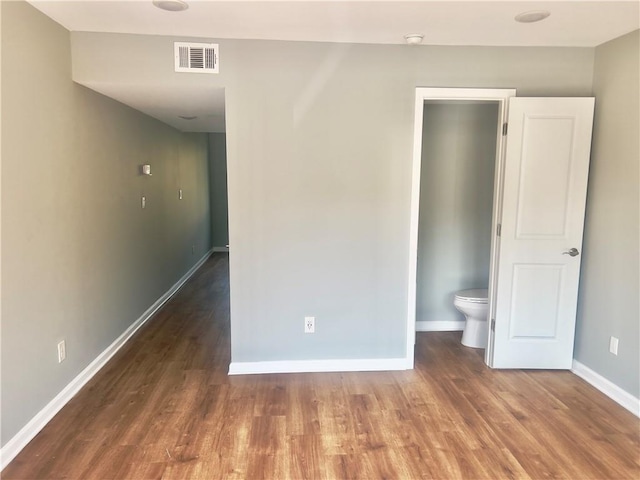 unfurnished bedroom featuring dark hardwood / wood-style floors