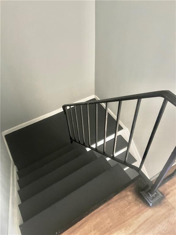 stairway with hardwood / wood-style flooring