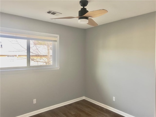 empty room featuring dark wood-type flooring and ceiling fan