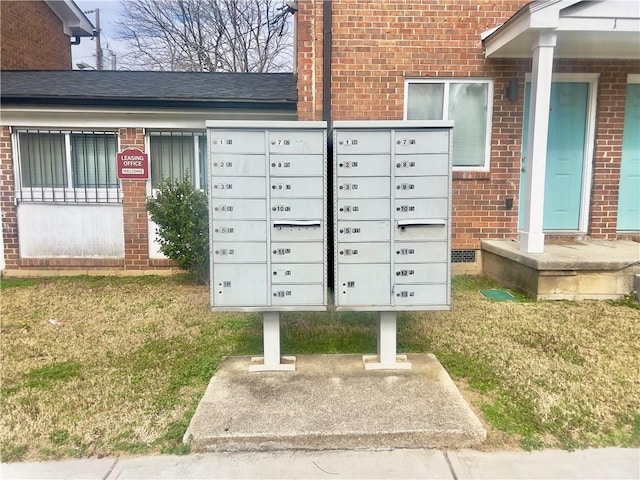 view of community with a lawn and mail boxes