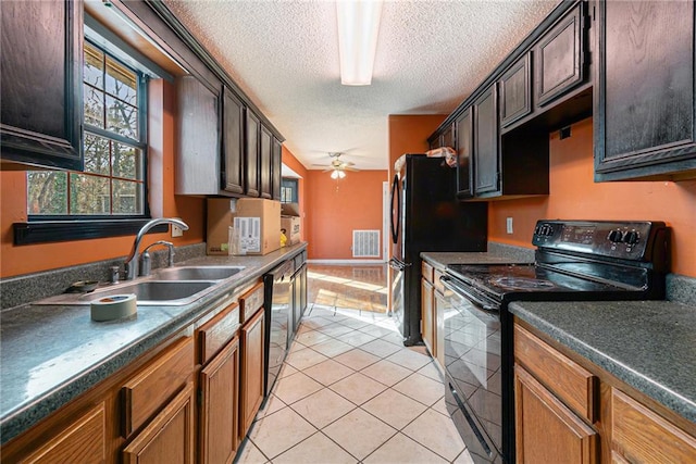 kitchen featuring sink, light tile patterned floors, ceiling fan, black appliances, and a textured ceiling