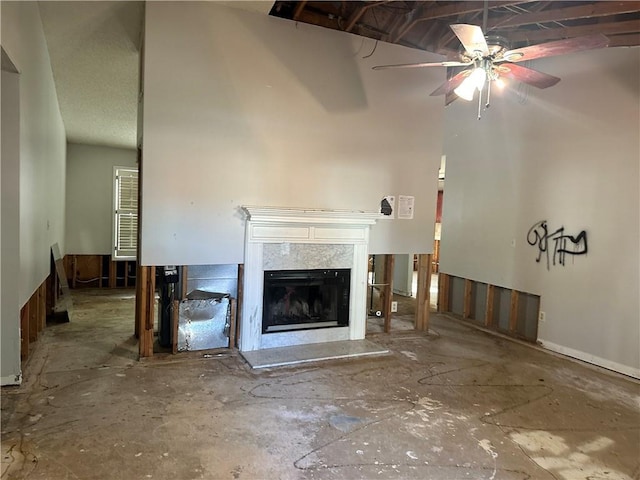 unfurnished living room with ceiling fan and a premium fireplace