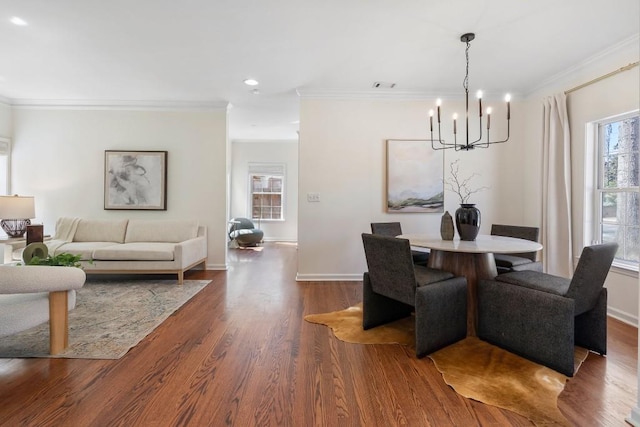 dining area featuring dark wood finished floors, baseboards, and ornamental molding