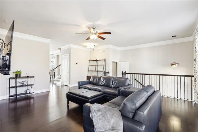 living room with dark wood-type flooring and ornamental molding