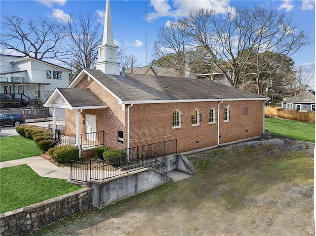 back of property featuring a yard