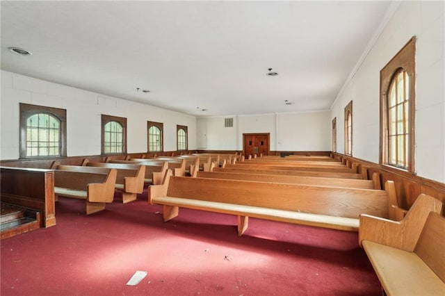 miscellaneous room featuring crown molding and carpet flooring