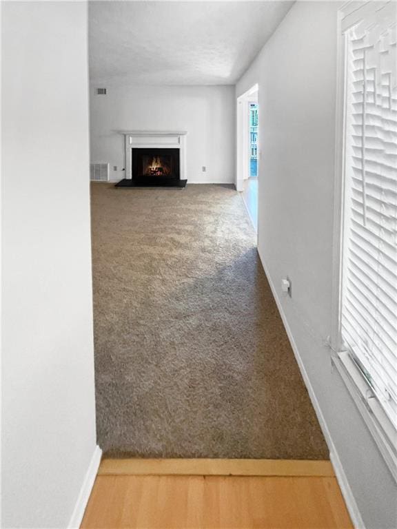 unfurnished living room featuring carpet