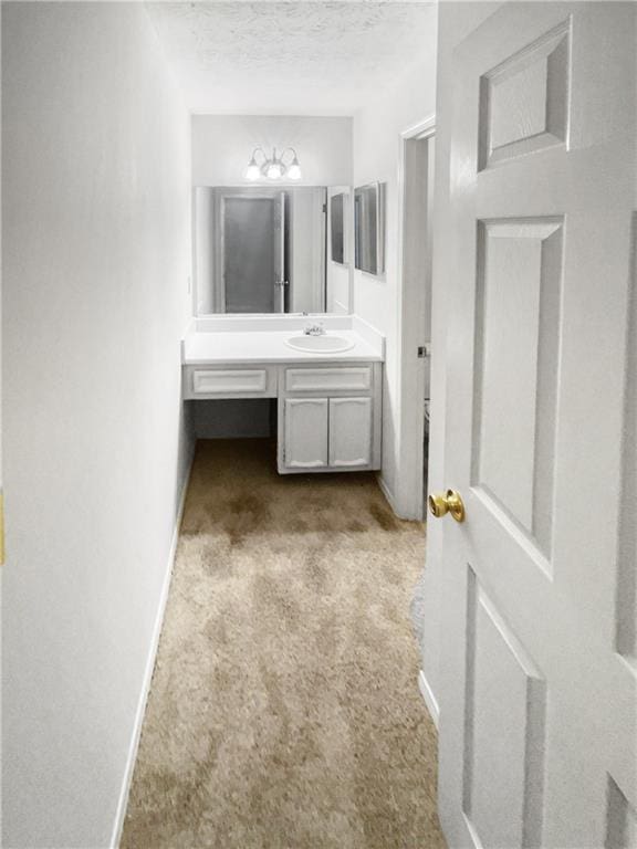 bathroom featuring a textured ceiling and vanity