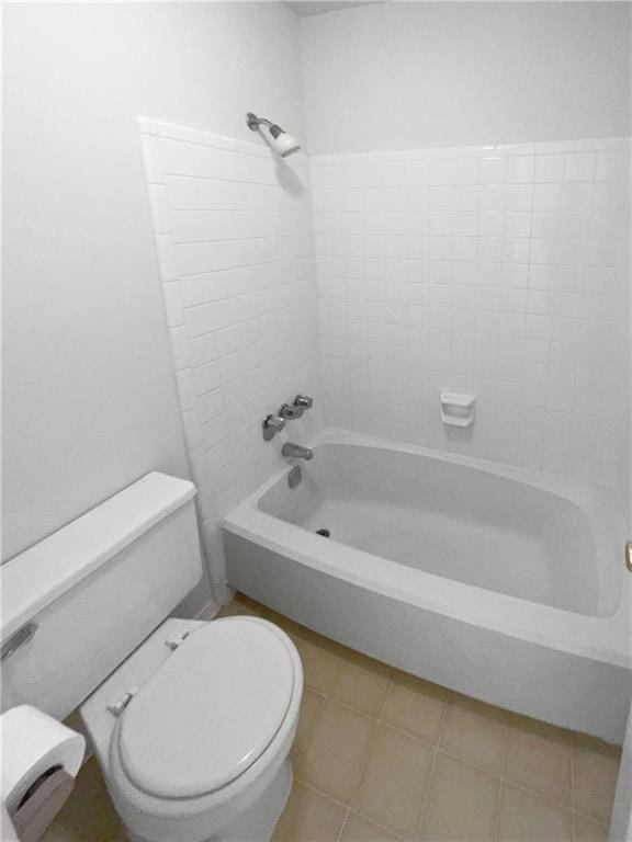 bathroom with washtub / shower combination and toilet