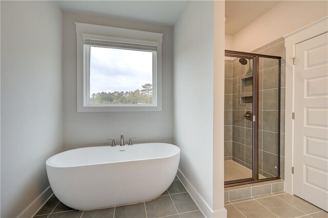 bathroom featuring tile patterned flooring and independent shower and bath