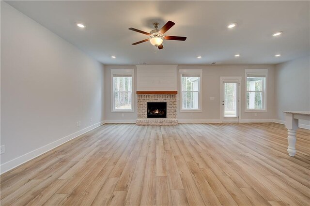 unfurnished living room with a healthy amount of sunlight and light wood-type flooring