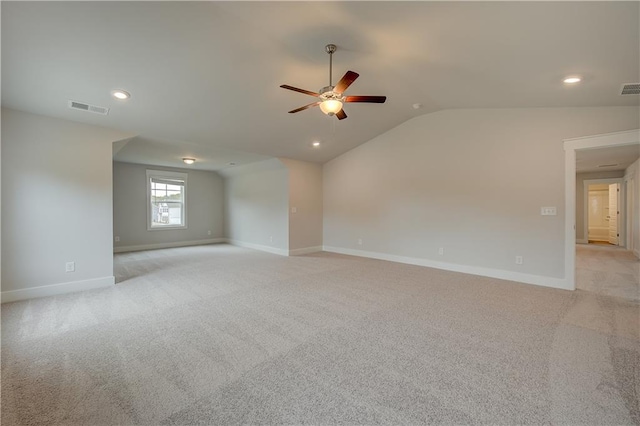 carpeted empty room featuring ceiling fan and lofted ceiling