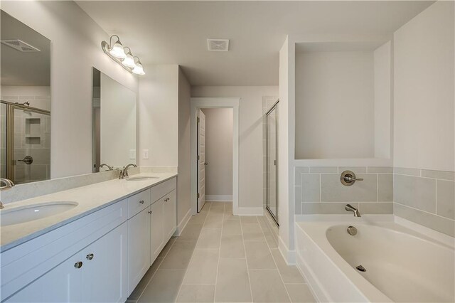 bathroom featuring tile patterned floors, vanity, and separate shower and tub