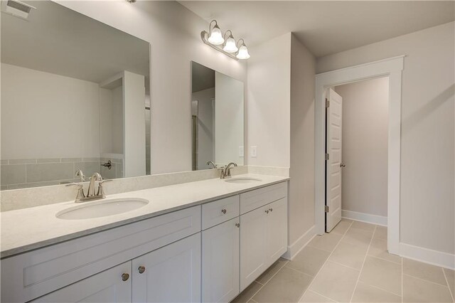 bathroom with tile patterned flooring and vanity