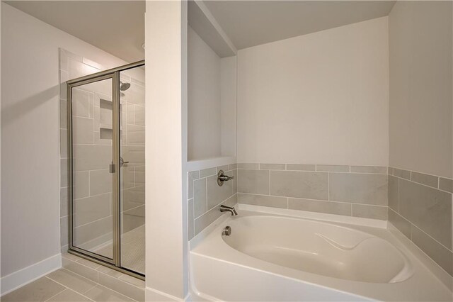 bathroom with tile patterned flooring and plus walk in shower