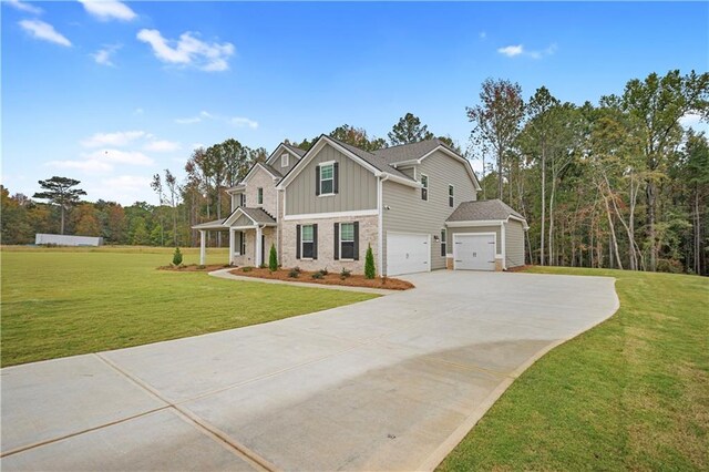 craftsman-style home featuring a front lawn and a garage