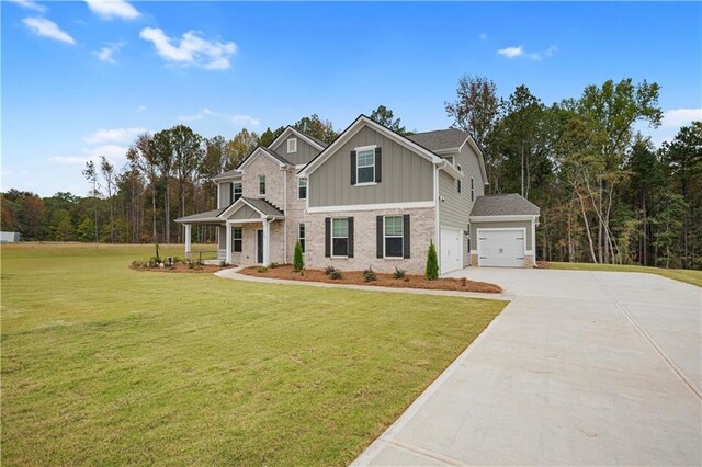 craftsman inspired home featuring a garage and a front yard