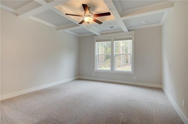 unfurnished room featuring ceiling fan, beam ceiling, light carpet, and coffered ceiling