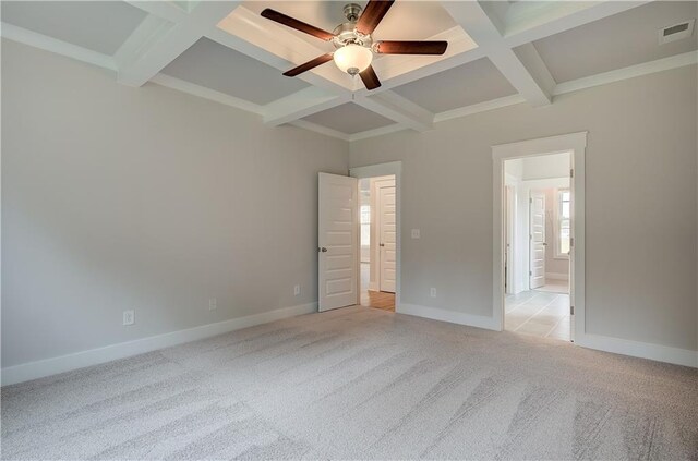 unfurnished bedroom featuring beamed ceiling, ceiling fan, light colored carpet, and coffered ceiling