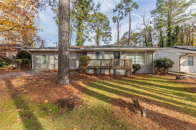 view of front of home with a front lawn and a deck