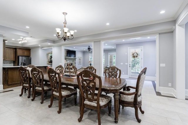 dining space featuring ceiling fan with notable chandelier, ornamental molding, and light tile patterned floors