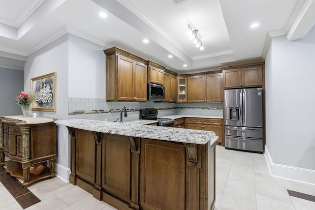 kitchen with stainless steel appliances, kitchen peninsula, decorative backsplash, and light stone countertops