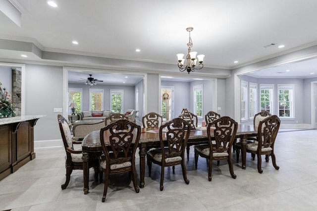 dining room featuring light tile patterned flooring, ceiling fan with notable chandelier, ornamental molding, and a healthy amount of sunlight